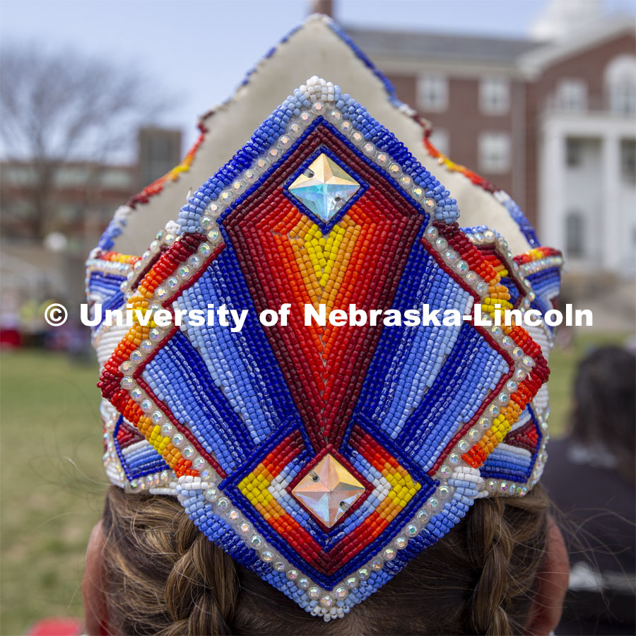 Detail of the beadwork in the regalia of Bridget Morris. 2022 UNITE powwow to honor graduates (K through college). Held April 23 on the greenspace along 17th Street, immediately west of the Willa Cather Dining Center. This was UNITE’s first powwow in three years. The MC was Craig Cleveland Jr. Arena director was Mike Wolfe Sr. Host Northern Drum was Standing Horse. Host Southern Drum was Omaha White Tail. Head Woman Dancer was Kaira Wolfe. Head Man Dancer was Scott Aldrich. Special contest was a Potato Dance. April 23, 2023. Photo by Troy Fedderson / University Communication.